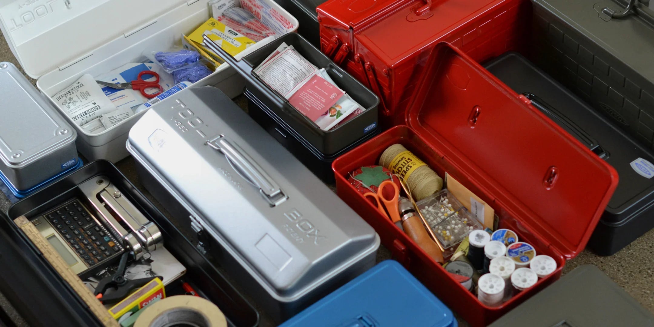 Heavy-duty TOYO Steel toolboxes and metal storage cases organizing multi-tools, gear, and utility supplies.