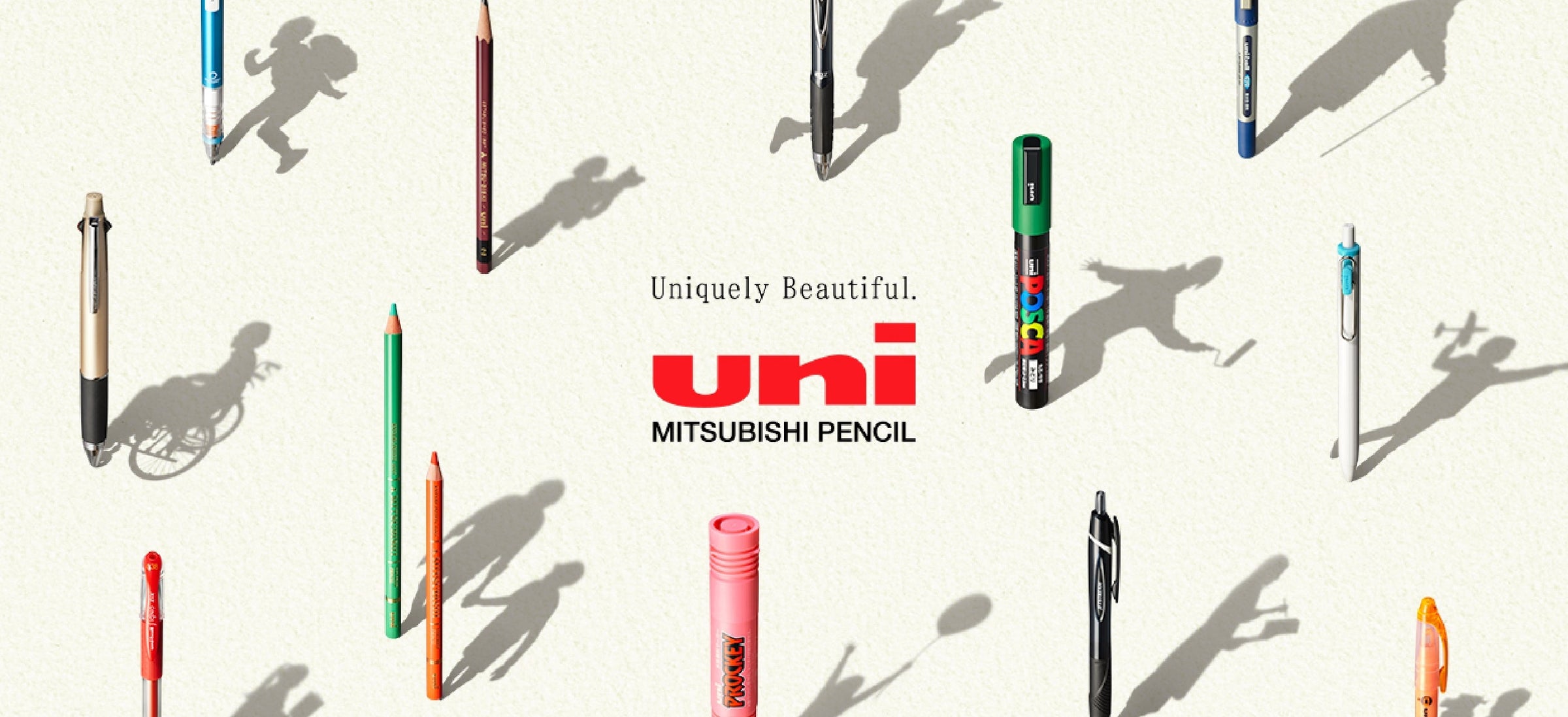 Japanese stationery arrangement of Uni gel pens, mechanical pencils, and a Posca marker by Mitsubishi Pencil, featuring the logo.