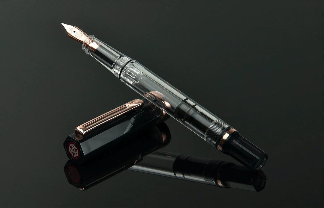 TWSBI ECO Fountain Pen – Smoke Rose Gold on a reflective black surface