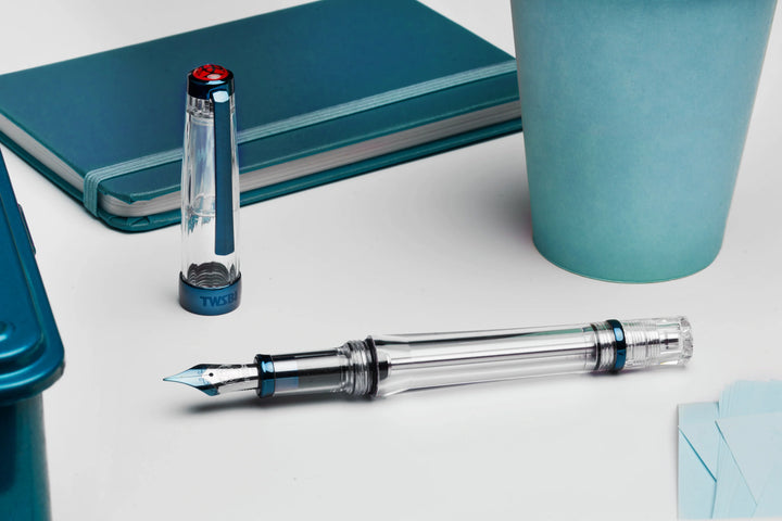 TWSBI VAC700R Fountain Pen – Kyanite on a light surface with a notebook and cup in the background.
