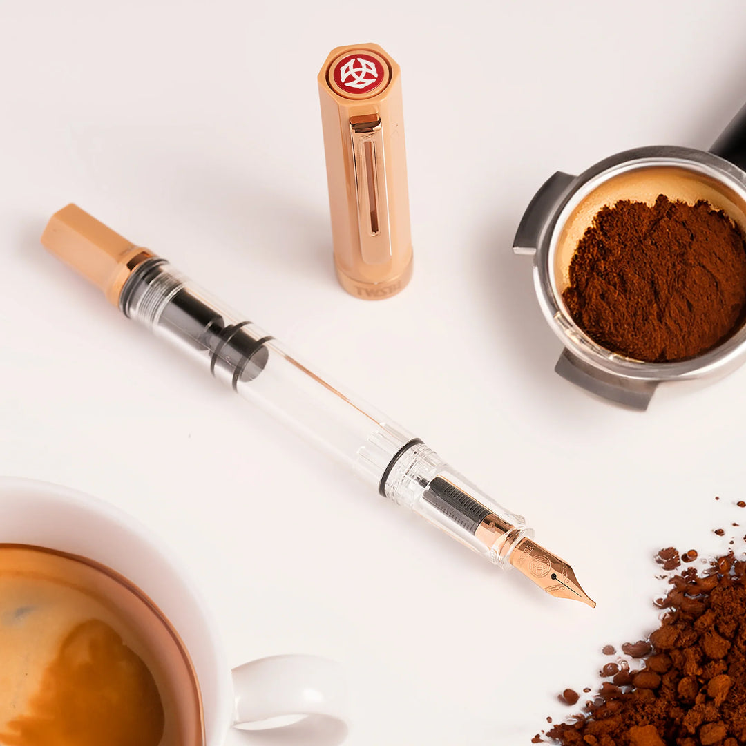 Coffee-themed TWSBI ECO Fountain Pen – Caffe Bronze with coffee beans and a cup of coffee on a white background