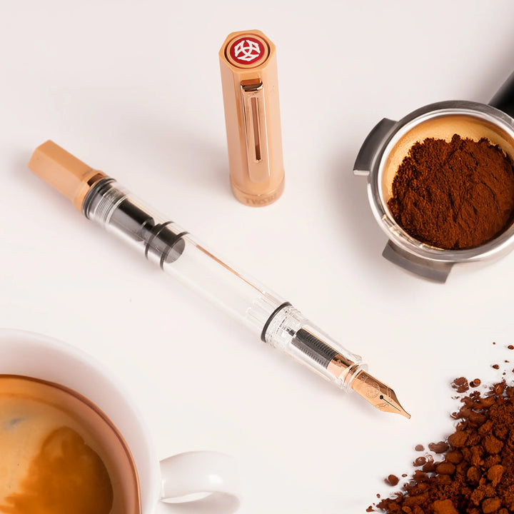 Coffee-themed TWSBI ECO Fountain Pen – Caffe Bronze with coffee beans and a cup of coffee on a white background