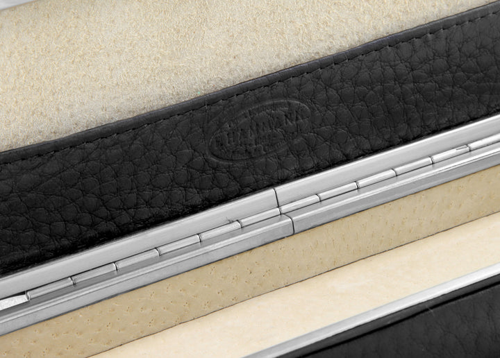 Macro detail of the F. Hammann 1864 heritage logo embossed on the integrated leather slip compartment located inside the lid.