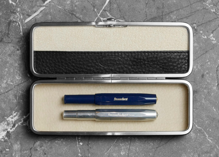 F. Hammann 3883 flexible framed case holding two Kaweco fountain pens securely under the adaptive interior bridge on a marble background.