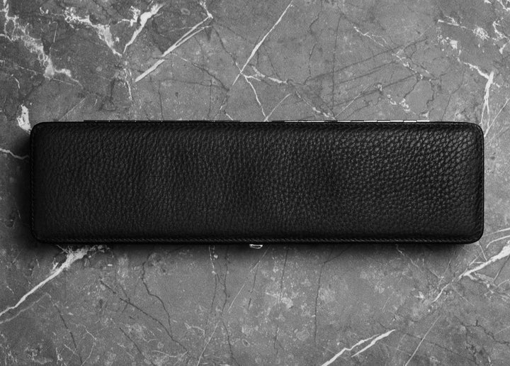 Closed F. Hammann 3976 Ruler Box in black Chervo calfskin resting on dark marble, showcasing its 33cm desk profile.