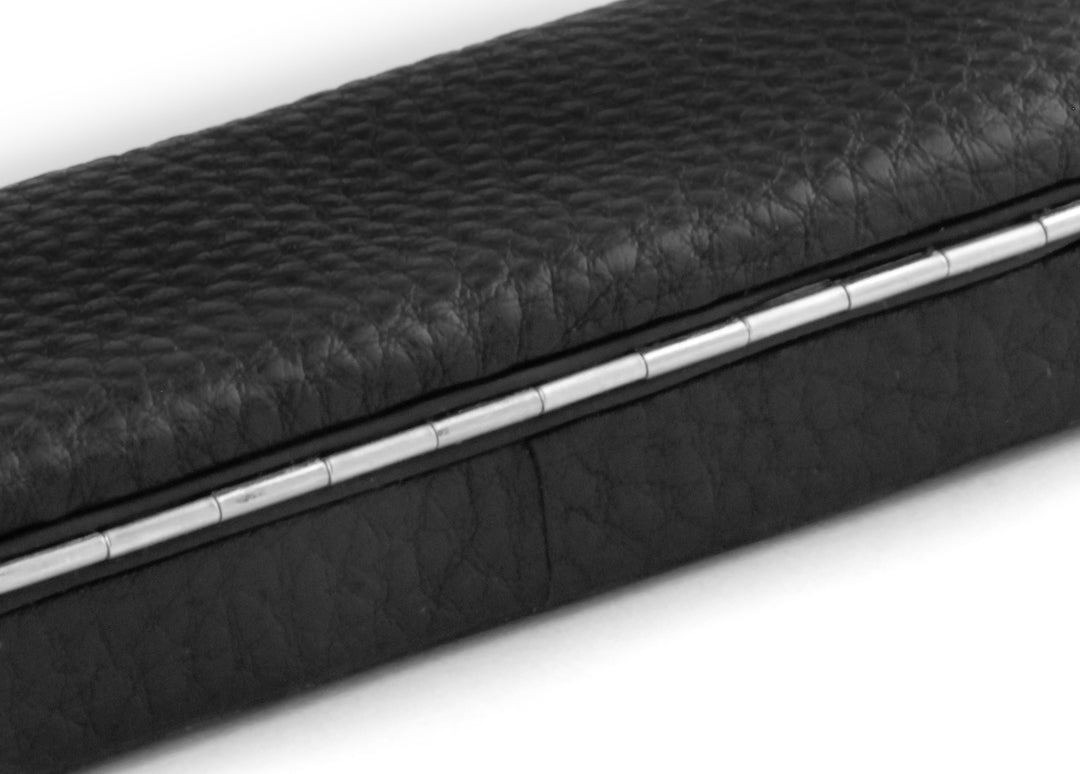 Macro texture shot of the continuous metal piano hinge and the breathable black Chervo calfskin leather on the F. Hammann 3983 pen case.