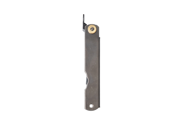 The reverse side of the closed Higonokami Titanium L friction folder, highlighting the smooth, minimalist titanium handle and the iconic chikiri lever protruding from the top.