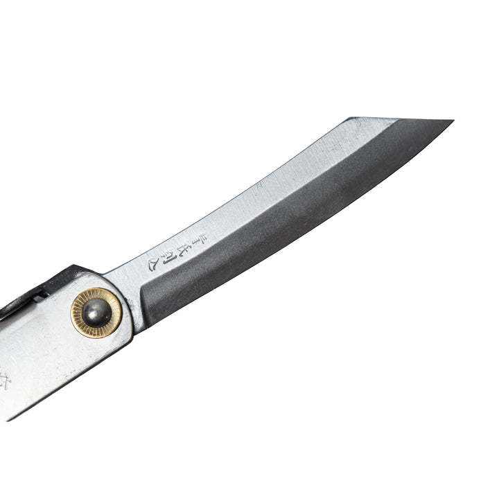 A close-up profile of the Higonokami L's Blue Paper Steel (Aogami) blade, revealing the precise cutting edge, distinct reverse-tanto geometry, and authentic maker's marks engraved near the base.