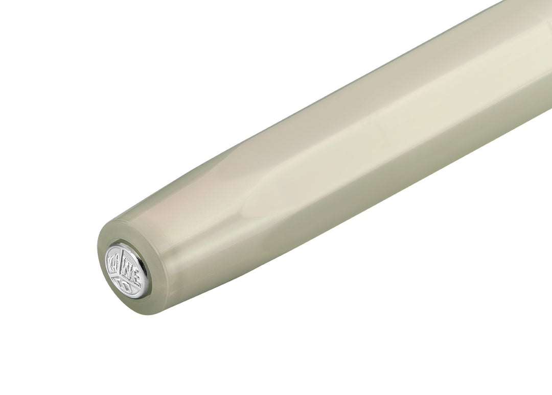 Close-up of the silver Kaweco logo medallion on the top of the Light Green octagonal cap.