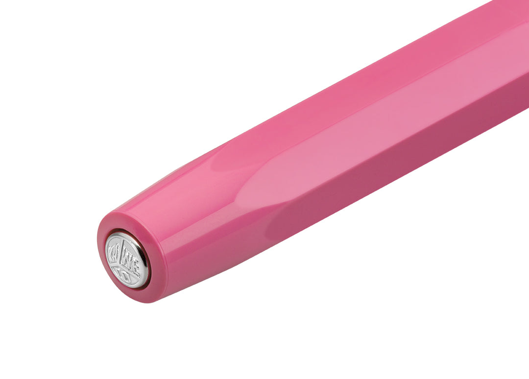 Close-up of silver Kaweco logo medallion on the pink octagonal cap of the fountain pen.