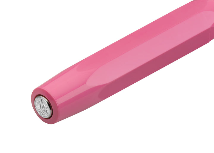 Close-up of silver Kaweco logo medallion on the pink cap of the Skyline Sport Rollerball.