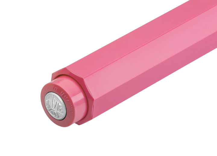 Close-up of Kaweco Skyline Sport Pink ballpoint push button featuring silver logo medallion and "Made in Germany" engraving.