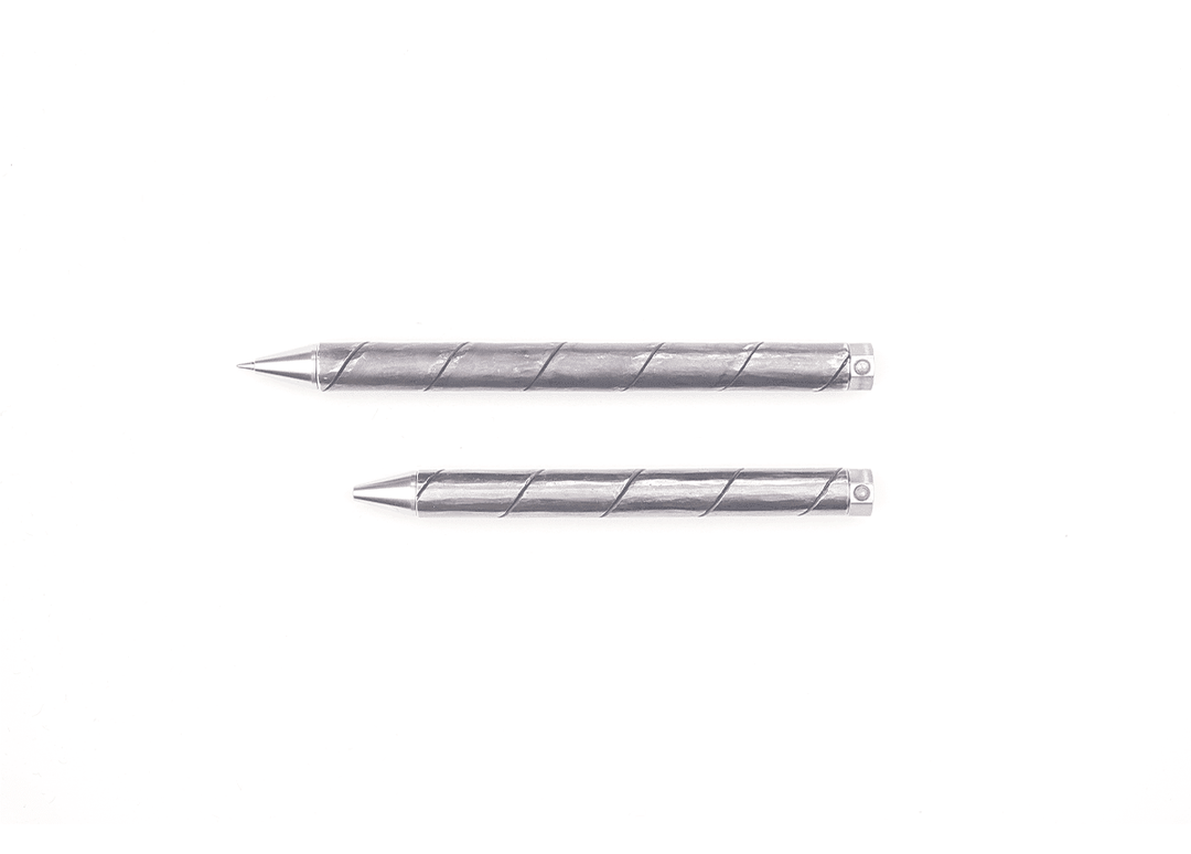 Horizontal size comparison of the longer 130mm and compact 110mm Kurogane Kazura Forged Finish ballpoint pens, showing their bare tapered writing tips.