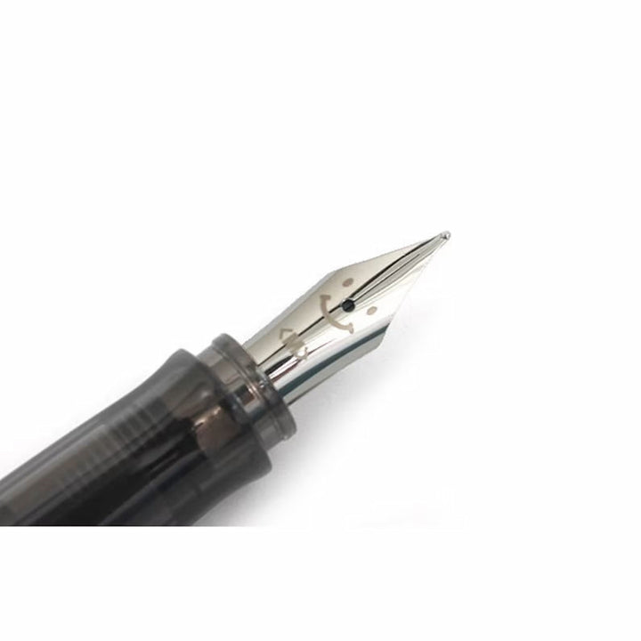 Detail view of the Pilot Kakuno Grey classic smiley face nib engraving on a steel nib.