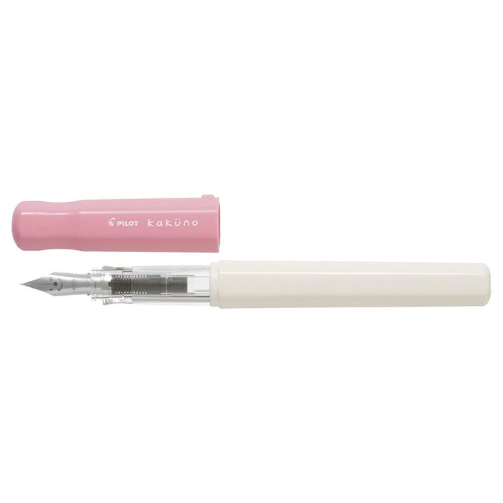 Uncapped Pilot Kakuno Soft Pink fountain pen showing the triangular grip and classic smiley face steel nib.