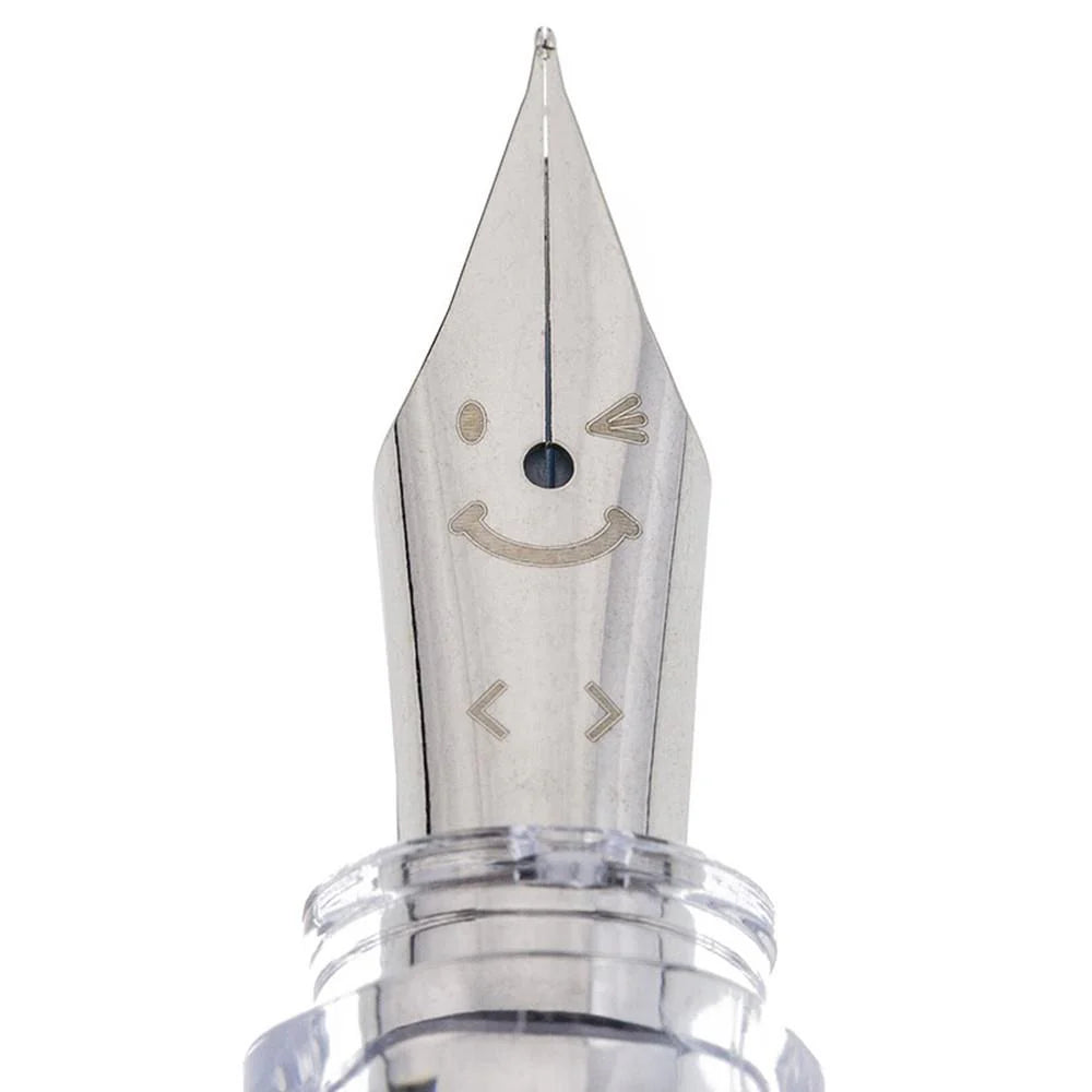 Detail view of the Pilot Kakuno Soft Pink classic smiley face nib engraving on a steel nib.