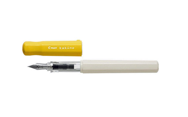 Uncapped Pilot Kakuno Soft Yellow fountain pen showing the triangular grip and classic smiley face steel nib.