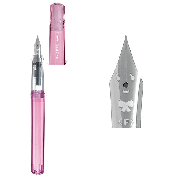 Close-up of the Pilot Kakuno Transparent Pink "Girl" nib featuring a smiley face with eyelashes and a ribbon bow engraving.