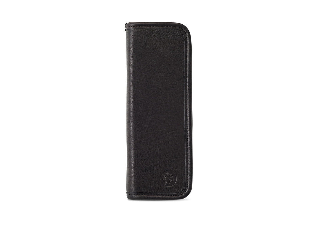 Front exterior view of the Sonnenleder Lenz Leather Pencil Case in Black, featuring deep matte-satin vegetable-tanned cowhide and the signature embossed sun logo.