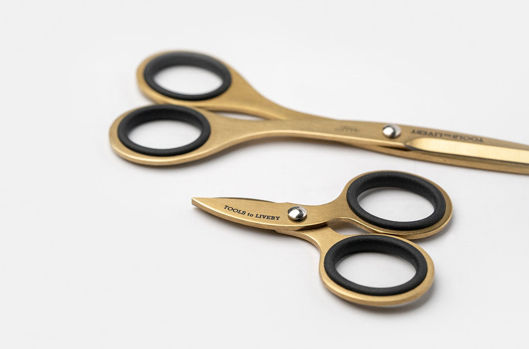 Size comparison highlighting the TOOLS to LIVEBY compact gold scissors line, featuring the pouch-ready 6.5-inch model alongside the ultra-compact 3-inch micro-EDC pocket scissors resting on a white background.
