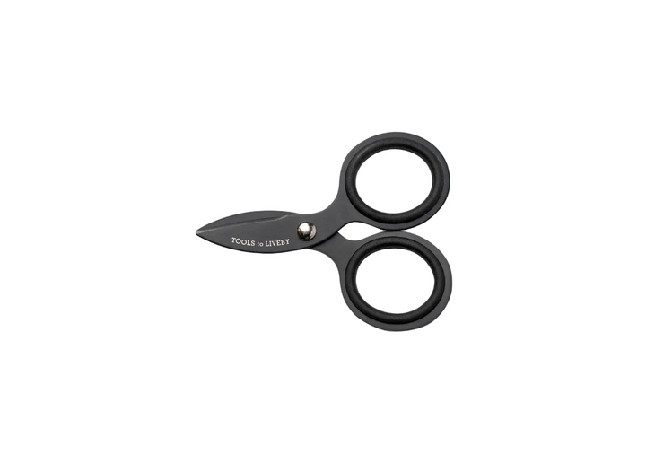 TOOLS to LIVEBY 3-inch matte black pocket scissors fully closed and resting horizontally on a minimalist white background, showcasing the ultra-compact, micro-EDC Japanese stainless steel profile.