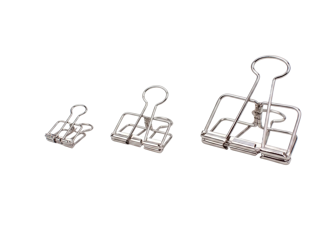 Three sizes of TOOLS to LIVEBY high-polish silver skeleton binder clips, including the small 19mm, medium 32mm, and large 51mm, arranged side-by-side against a crisp white background.