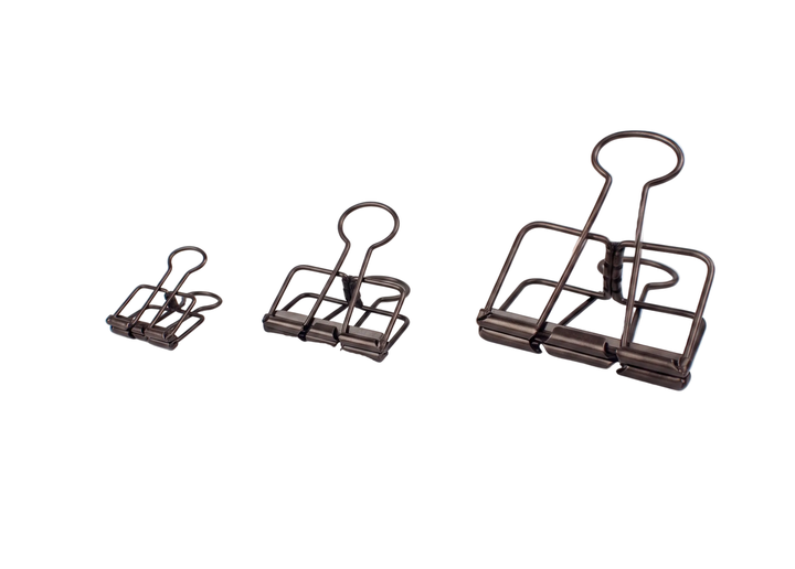 Three TOOLS to LIVEBY Skeleton Binder Clips in an antique bronze finish, displaying the small 19mm, medium 32mm, and large 51mm sizes side-by-side against a pure white background.