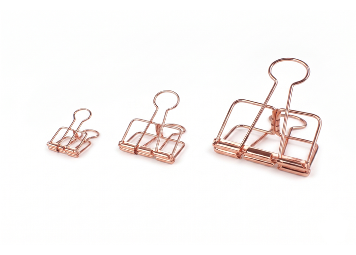 Three TOOLS to LIVEBY Rose Gold Skeleton Binder Clips: A sleek comparison view showing the small 19mm, medium 32mm, and large 51mm wire frame clips perfectly arranged against a minimalist white background.