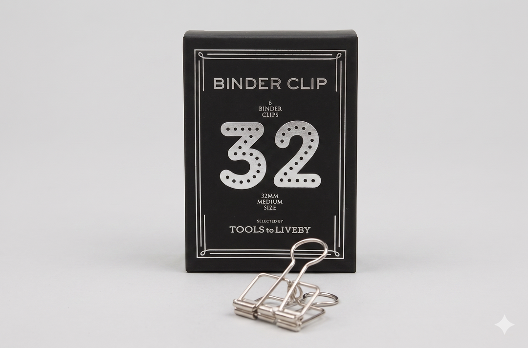 A medium 32mm TOOLS to LIVEBY silver skeleton binder clip displayed alongside its custom black paper box, highlighted by a dotted silver foil-stamped number 32.