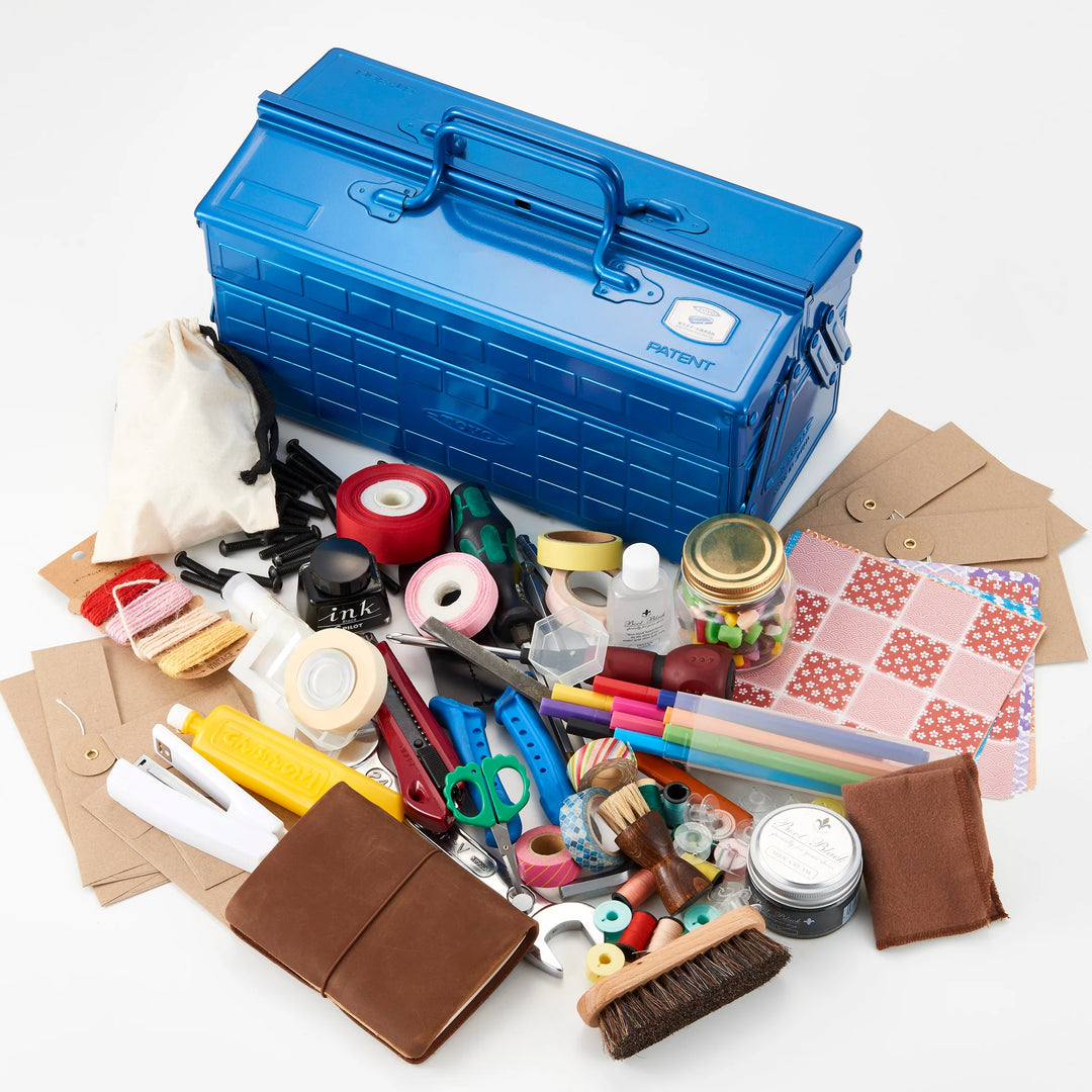 Blue TOYO ST-350 Cantilever Toolbox surrounded by a large collection of organized stationery, craft tools, notebooks, and sewing supplies.