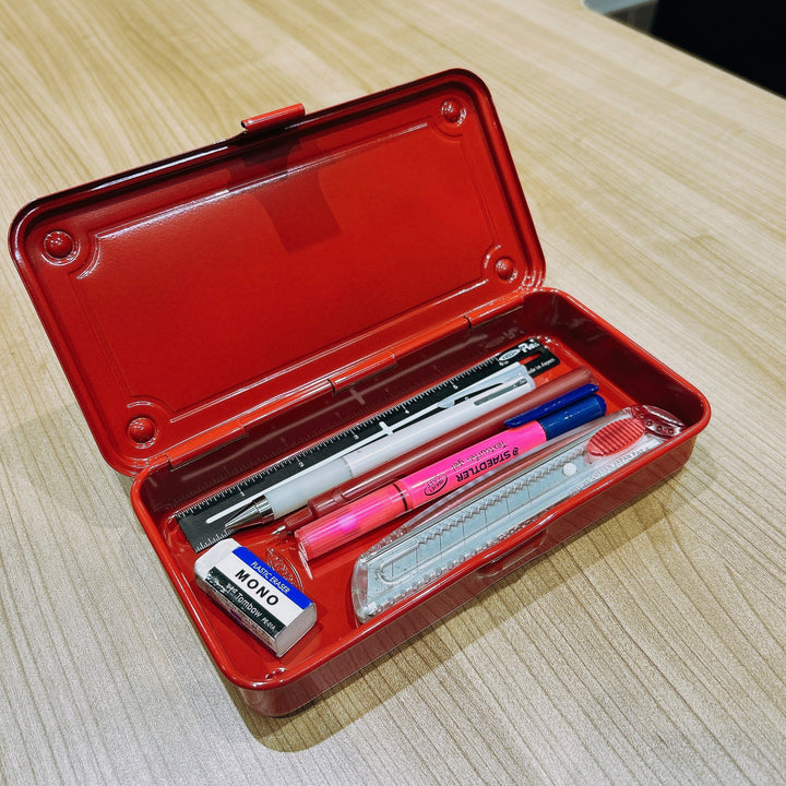 Open Red TOYO T-192 Steel Toolbox used as a desk organizer, perfectly sized to hold pens, a ruler, and stationery supplies.