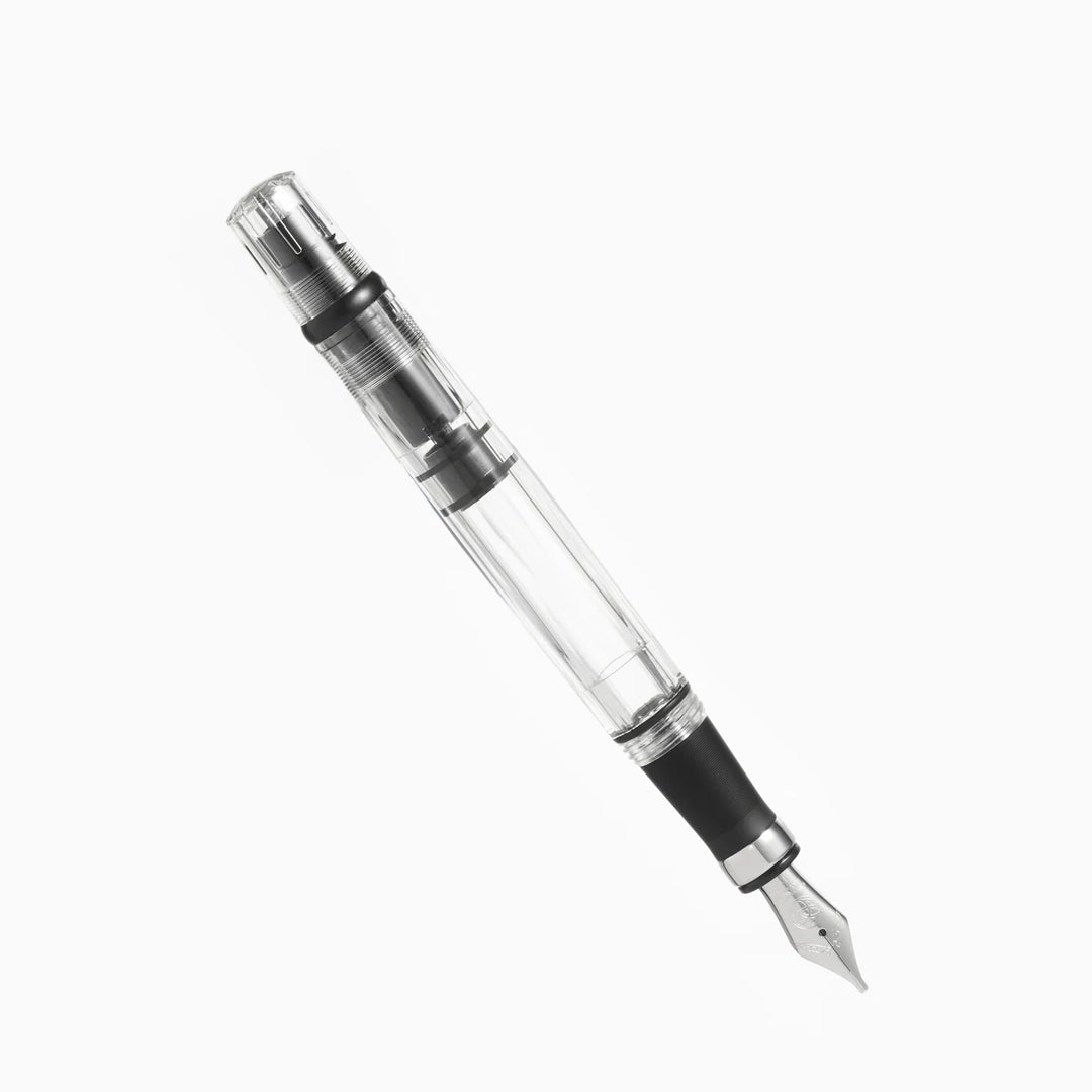 Uncapped TWSBI Diamond 580ALR Black fountain pen angled on a white background, highlighting the silver stainless steel Jowo nib, matte black ribbed aluminum grip, and clear high-capacity ink barrel.
