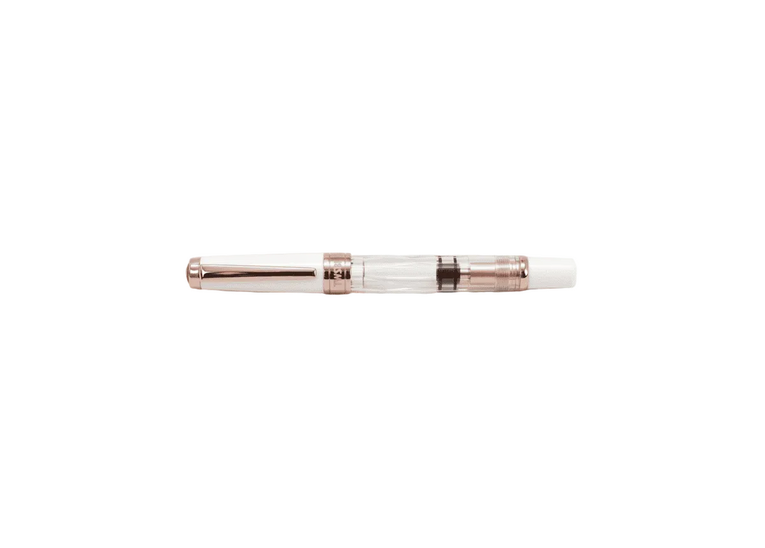 TWSBI Diamond 580 White Rose Gold II fountain pen shown capped against a white background, highlighting the clear faceted demonstrator barrel, solid white cap, and luxurious rose gold-plated trim.