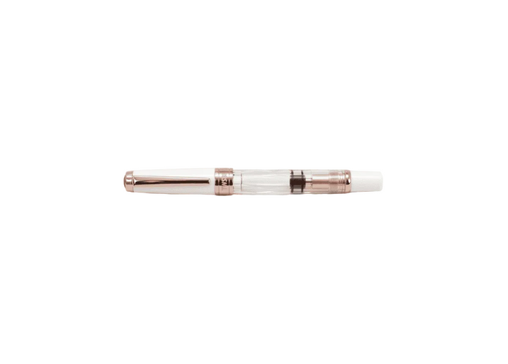 TWSBI Diamond 580 White Rose Gold II fountain pen shown capped against a white background, highlighting the clear faceted demonstrator barrel, solid white cap, and luxurious rose gold-plated trim.