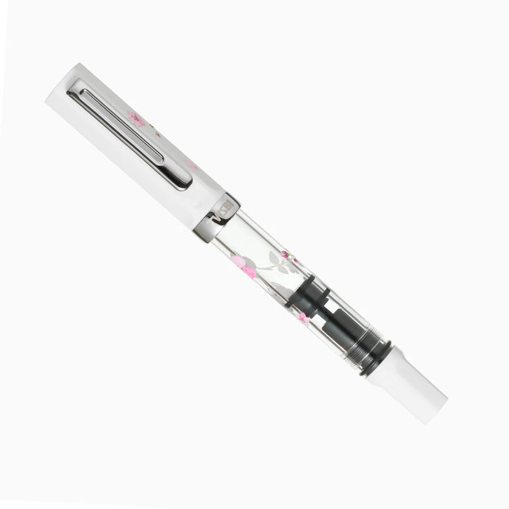 Fully capped TWSBI ECO Cherry Blossom limited edition fountain pen on a white background, showing the white cap, clear printed barrel, and white piston knob.