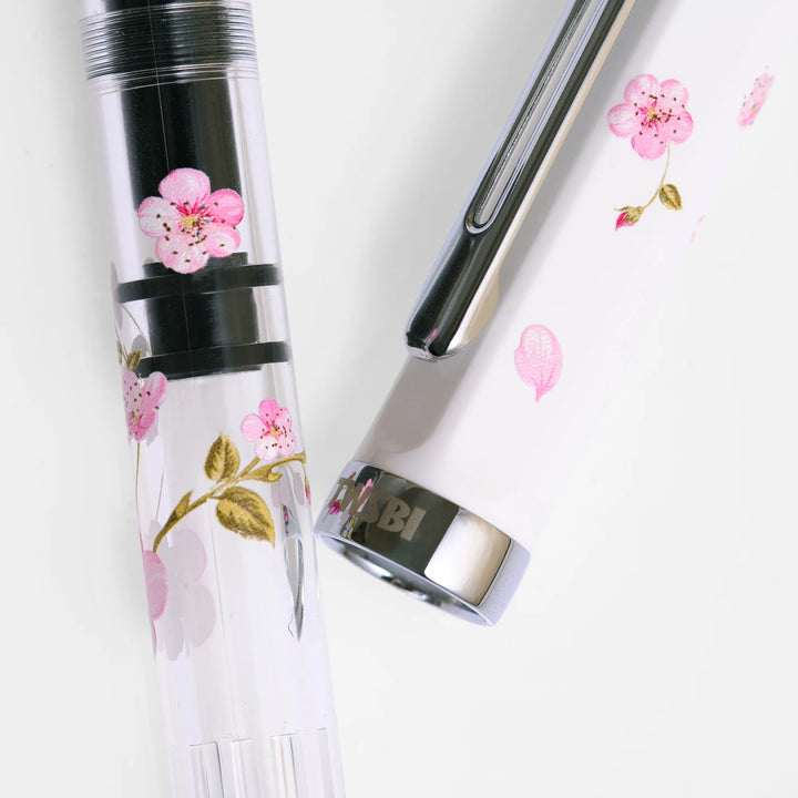 Macro detail of the TWSBI ECO Cherry Blossom demonstrator barrel, showing the internal black piston mechanism beneath the screen-printed pink flowers.
