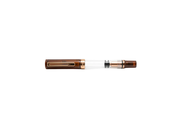 Perfectly horizontal profile of the capped TWSBI ECO Rootbeer Bronze fountain pen centered on a pure white background. The clean, straight-on composition emphasizes the clear demonstrator barrel, the warm translucent brown rootbeer resin cap and blind cap, and the vintage bronze-plated pocket clip and trim rings.