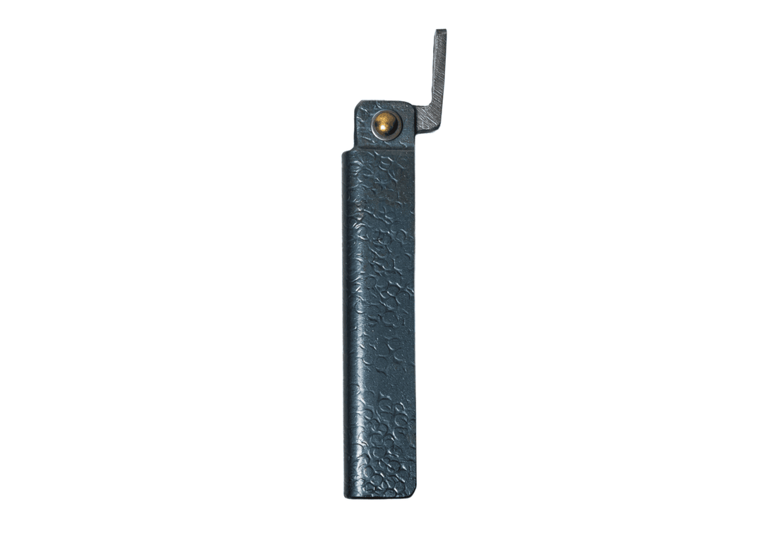 Profile view of the closed large Tomita Higo friction folder, highlighting the hand-forged black hammered iron handle and brass pivot.