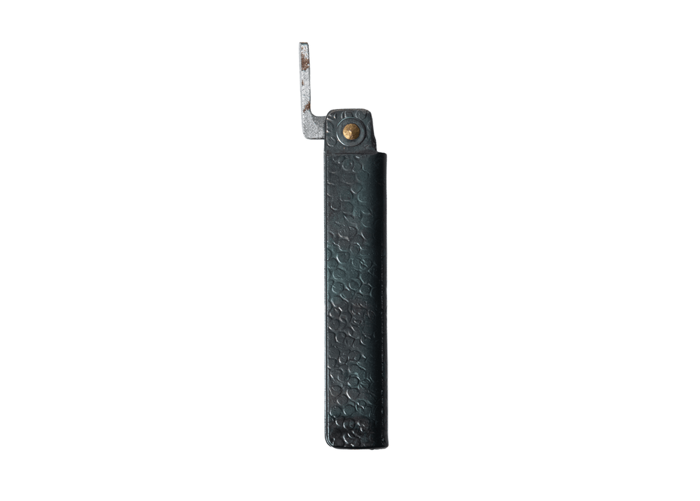 Profile view of the closed Tomita Higo friction folder, highlighting the hand-forged black hammered iron handle and brass pivot.