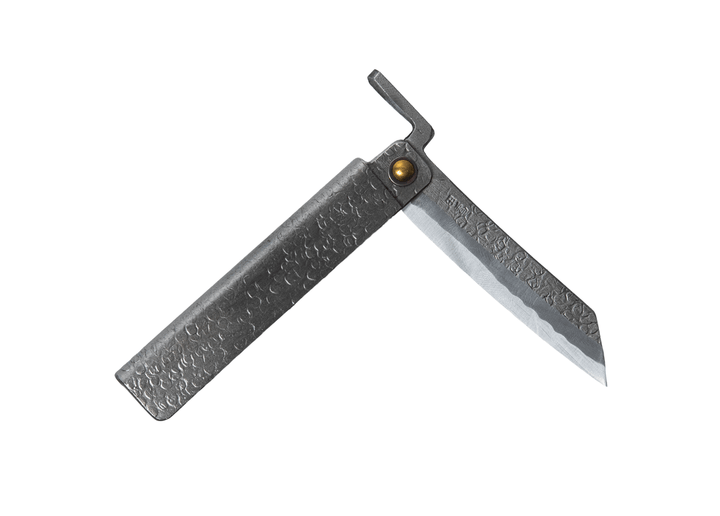 Partially open Tomita Higo knife featuring a silver tsuchime hammered iron handle and a traditional profile Shirogami steel blade with Midareba pattern.