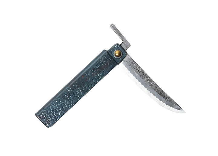 Partially open Tomita Higo knife featuring a black tsuchime hammered iron handle and a Kengata profile Shirogami steel blade with Midareba pattern.