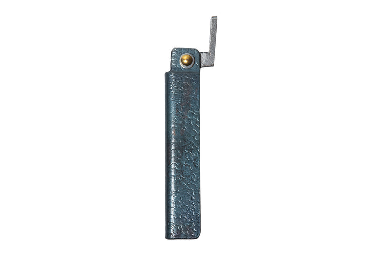 Profile view of the closed large Tomita Higo friction folder, highlighting the hand-forged black hammered iron handle and brass pivot.