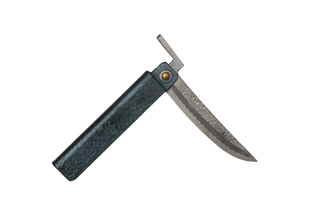 Partially open Tomita Higo knife featuring a black tsuchime hammered iron handle and a Shirogami steel Kengata blade with Midareba pattern.