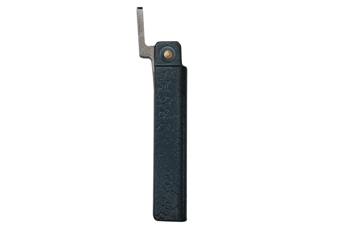 Profile view of the closed Tomita Higo friction folder, highlighting the hand-forged black hammered iron handle and brass pivot.