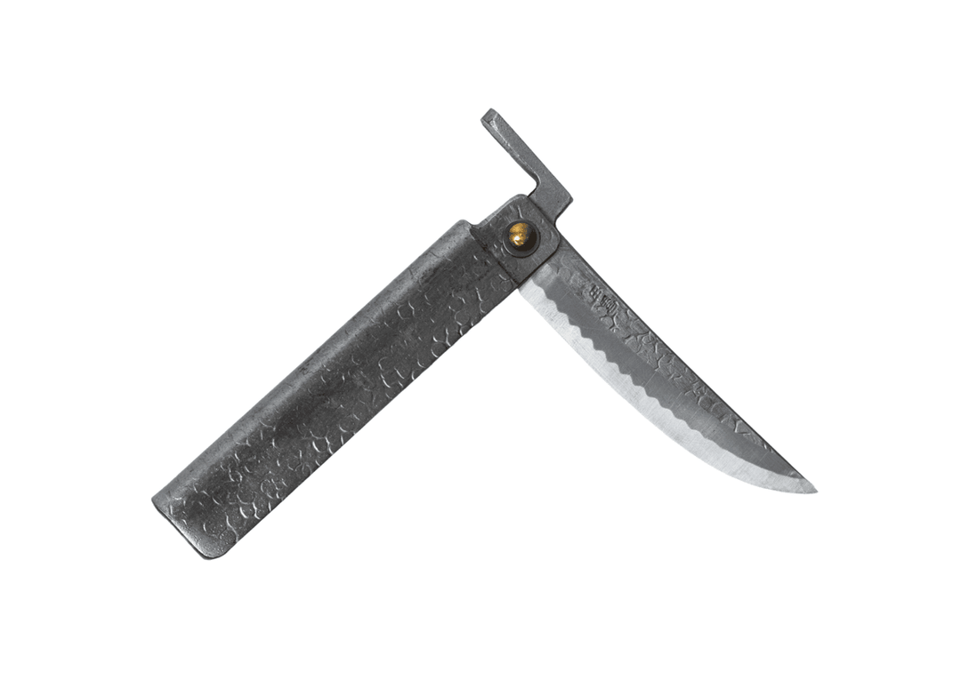 Partially open Tomita Higo knife featuring a silver tsuchime hammered iron handle and a Kengata profile Shirogami steel blade with Midareba pattern.