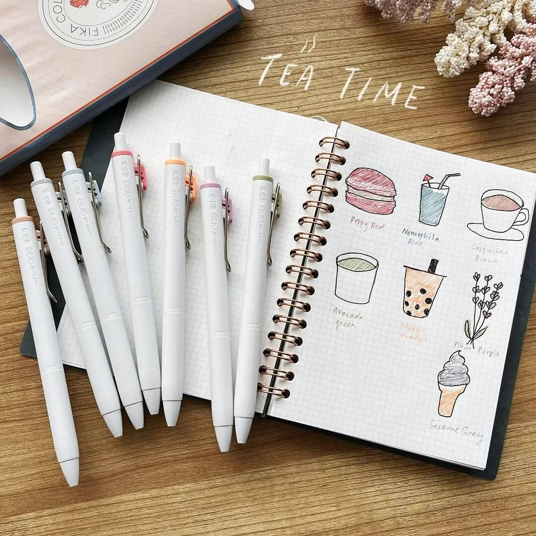 Bullet journal spread featuring cafe-inspired doodles drawn with the limited edition Uni-ball One Fika 8-Color Gel Pen Set.