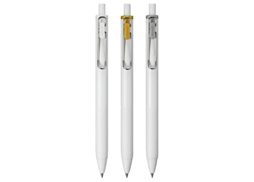 Studio lineup of the three Uni-ball One 0.38mm metallic gel pens showing White, Gold, and Silver wire clips.
