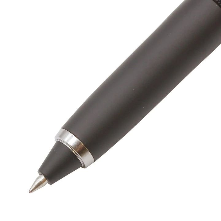 Close-up of the 0.5 mm tip and tapered black nose cone with silver ring on the Uni-ball ZENTO Signature 3-Colour ballpoint pen.