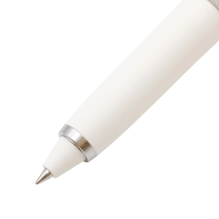 Close-up of the 0.38 mm fine tip and tapered white grip section on the Uni-ball ZENTO Signature 3-Colour ballpoint pen.
