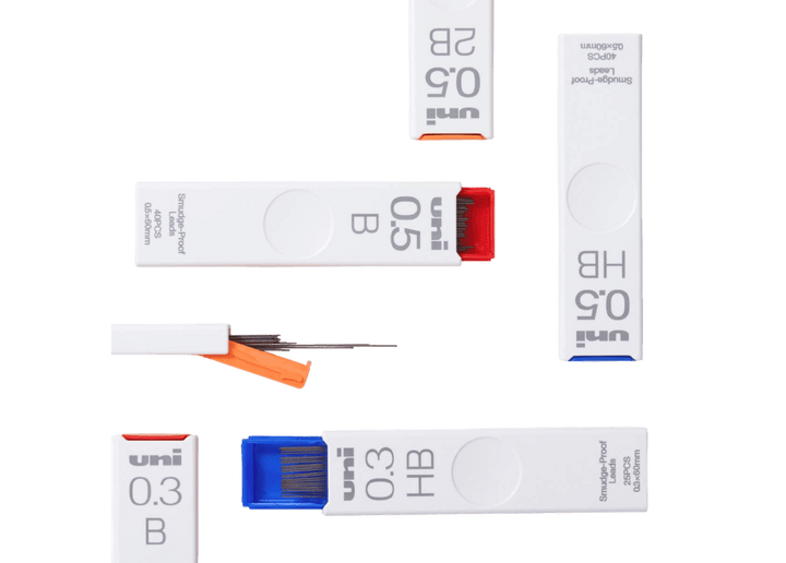 Collection of uni Smudge-Proof pencil lead refill cases in various sizes and hardness grades.